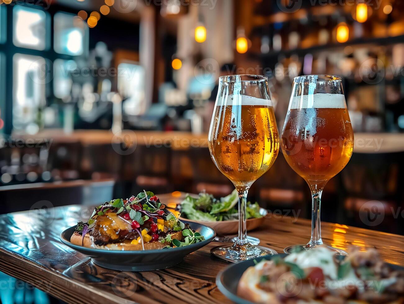 Two glasses of craft beer with assorted gourmet dishes on a wooden table in a cozy pub setting with warm lighting photo