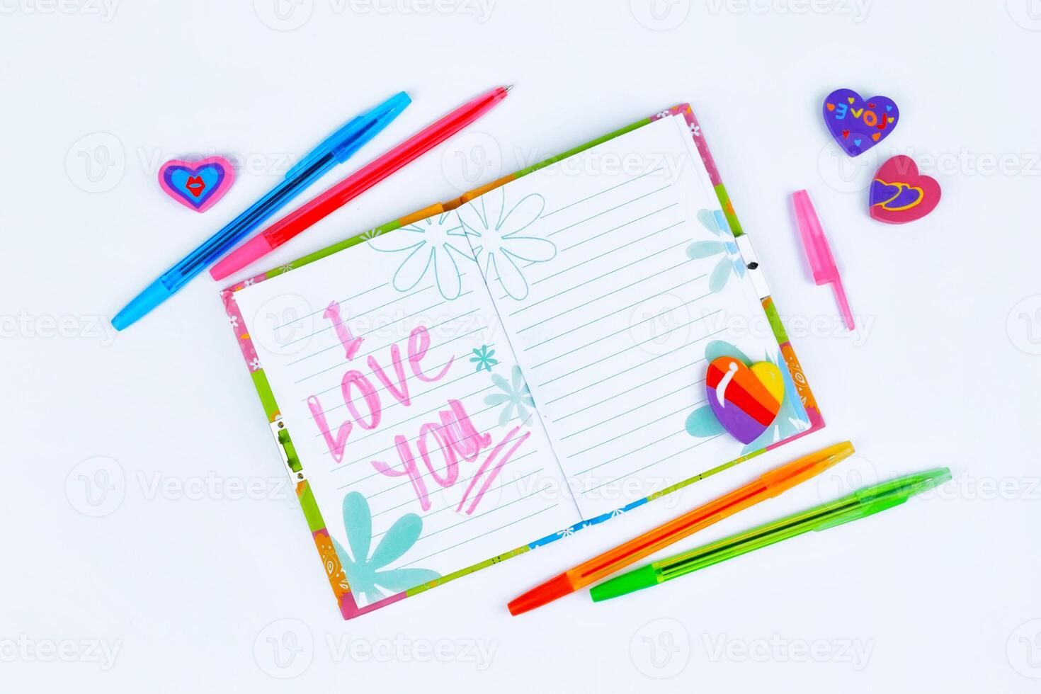 Notebook with stationery on a white table photo