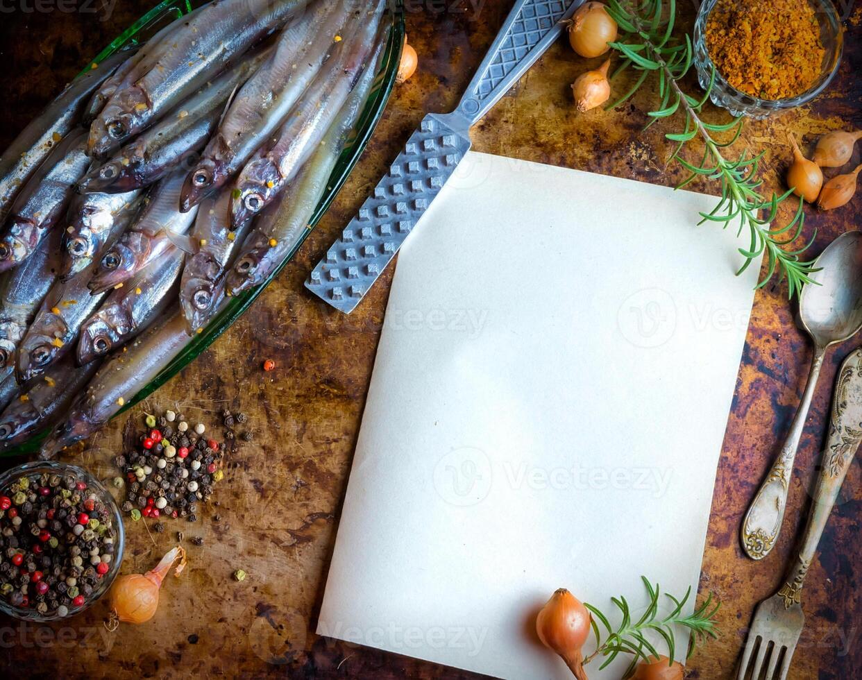 Fresh fish top view. Spicy herb and vegetables. Spice on wooden board. Healthy food cooking. photo