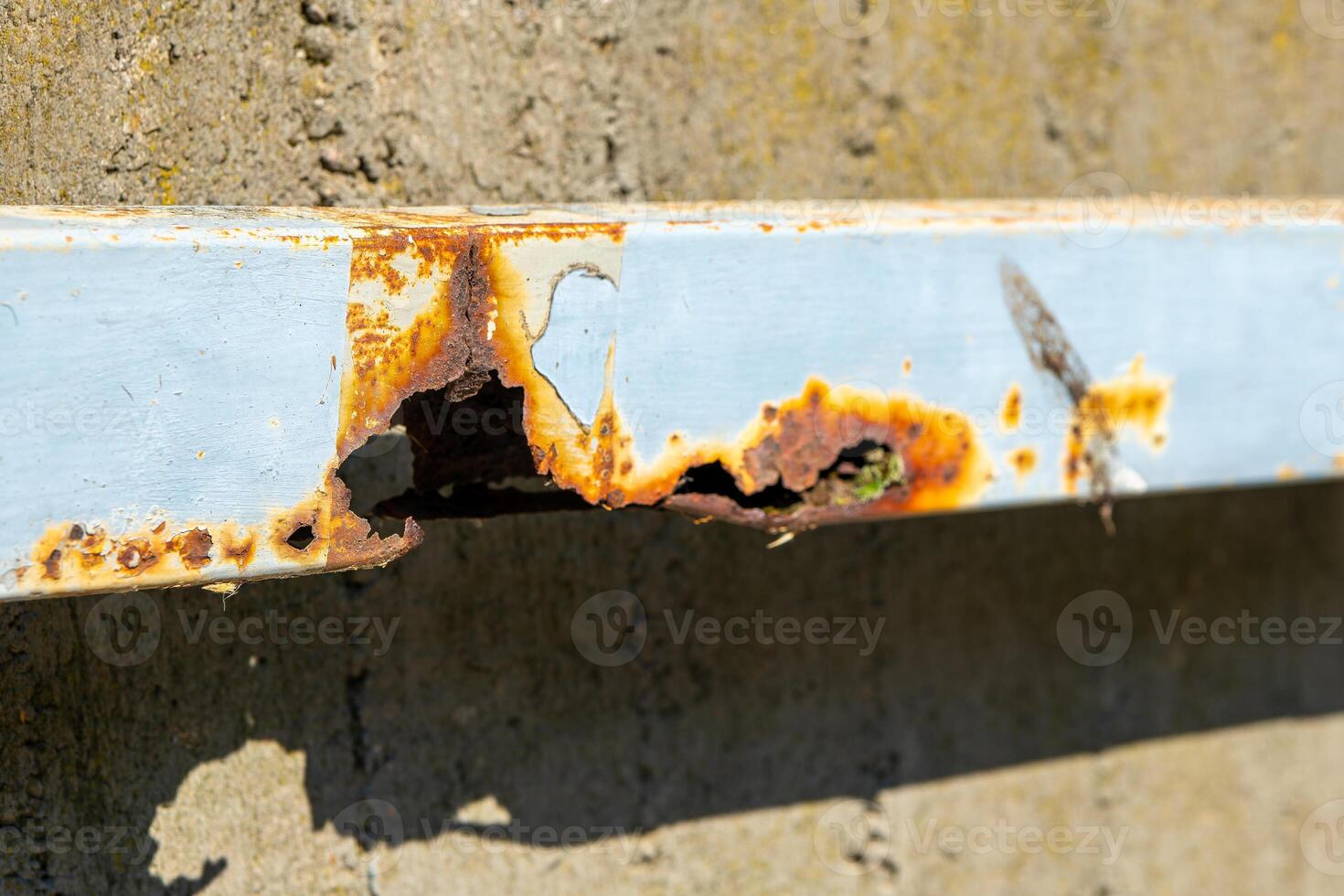 rusty metal beam with holes in it photo