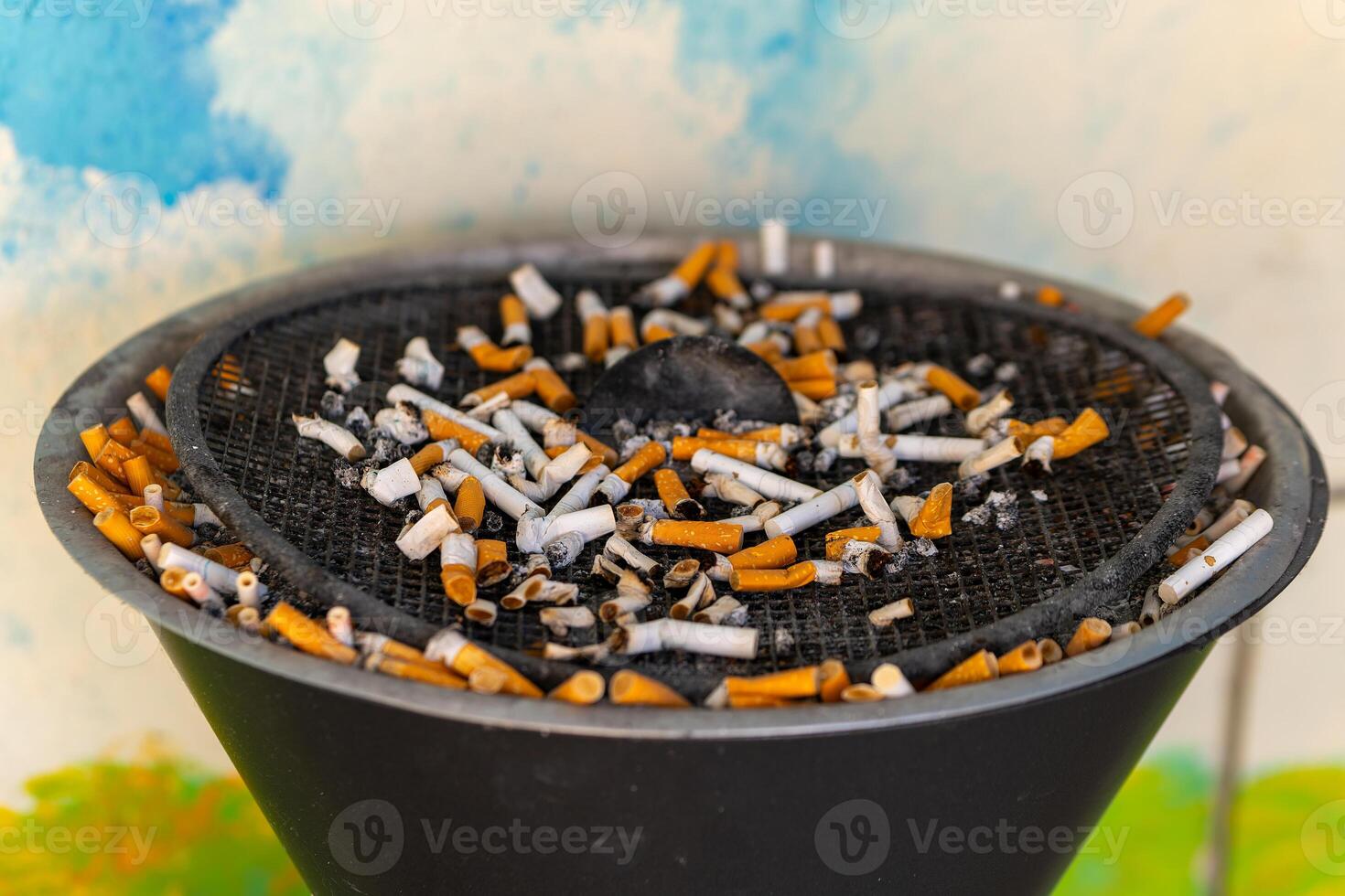 black bowl full of cigarette butts and ash photo