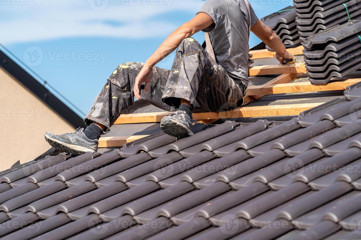 installation of roofing by a craftsman, ceramic tiles on wooden beams photo
