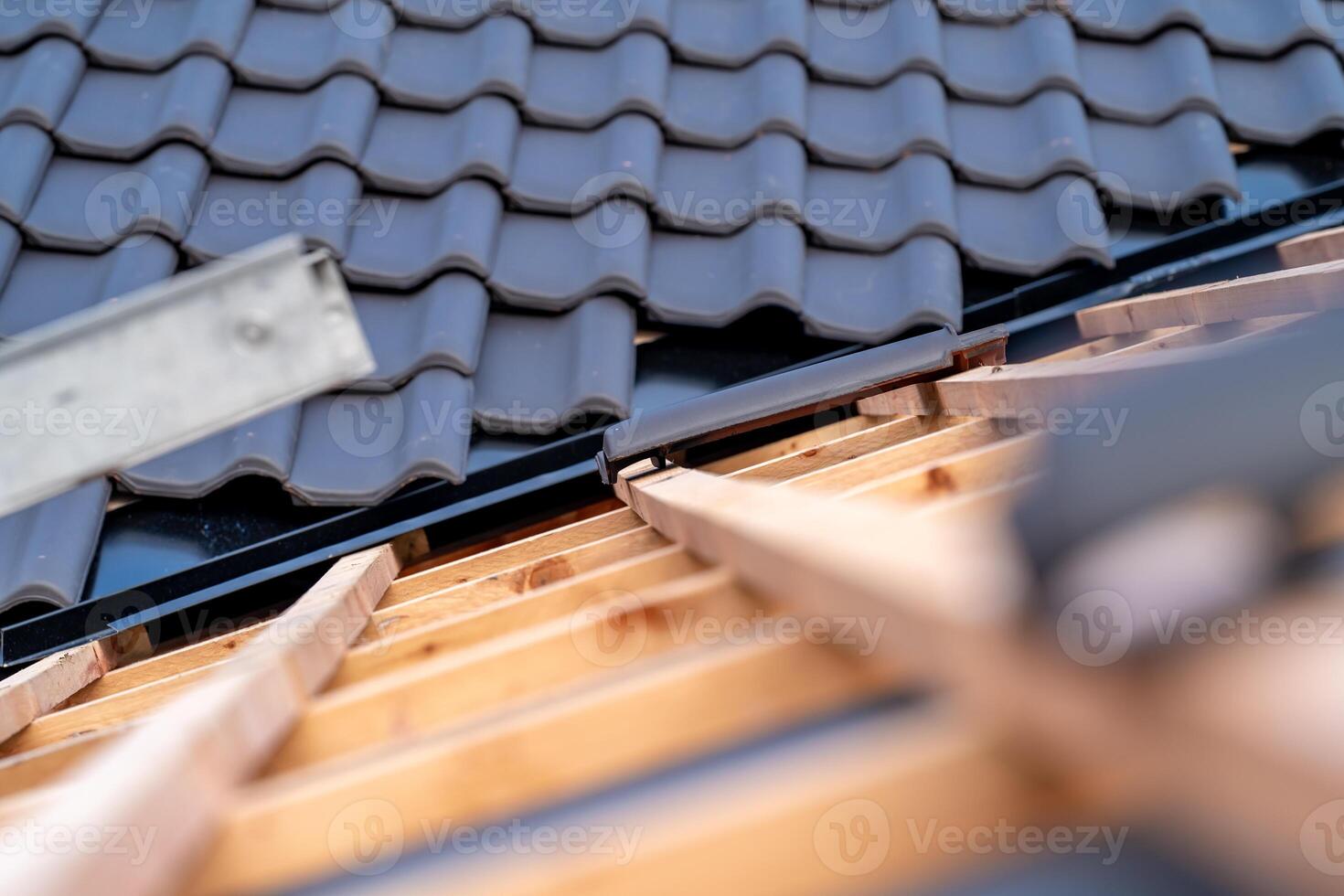 construction of the roof of a family house on wooden beams made of ceramic tiles photo