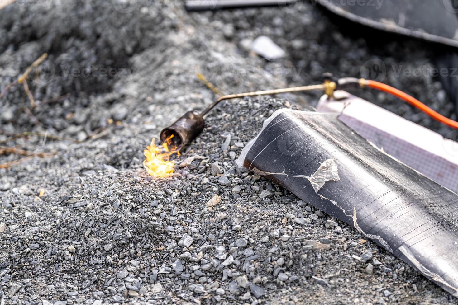 flame of fire from a gas burner to heat asphalt belts for building insulation photo