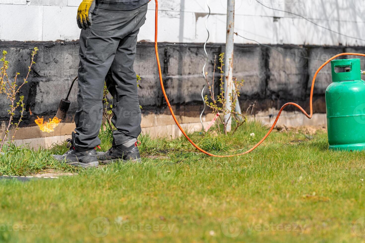 craftsman with a gas tank for a fire on a construction site photo