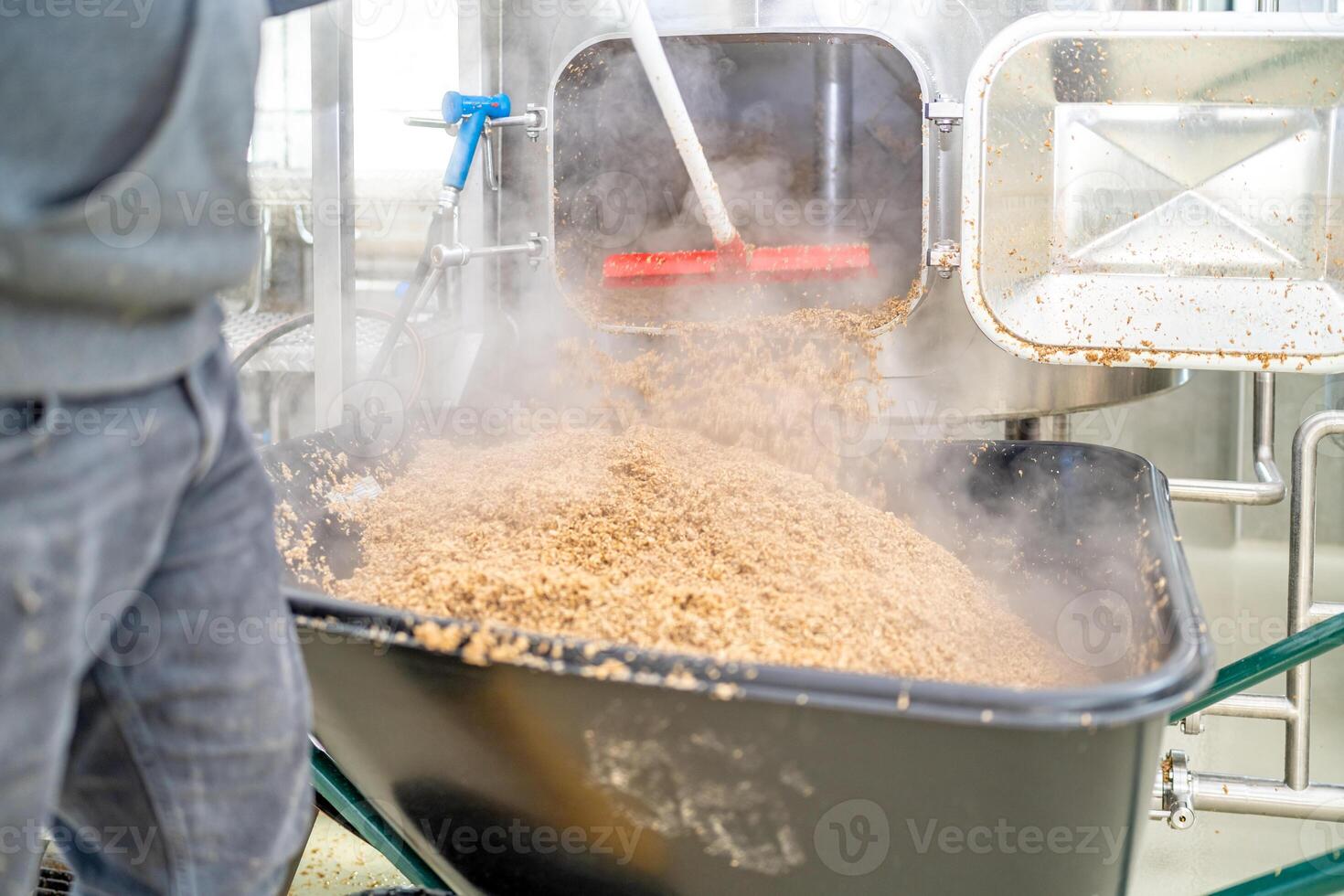 cleaning the boiler from residual malt after brewing beer in the brewery photo