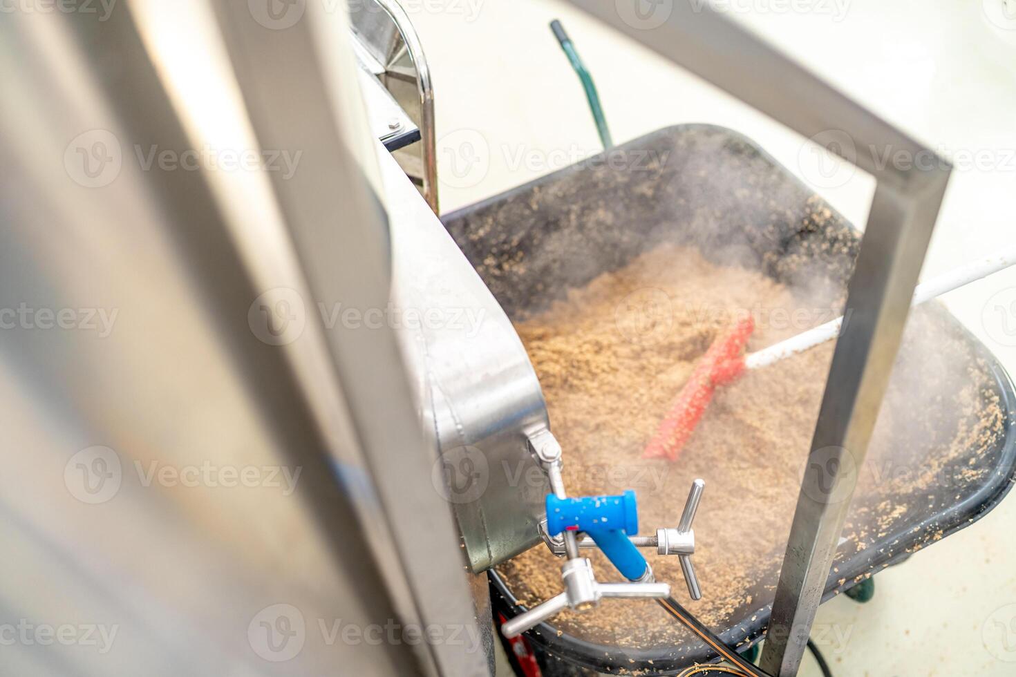 cleaning the boiler from residual malt after brewing beer in the brewery. top view photo