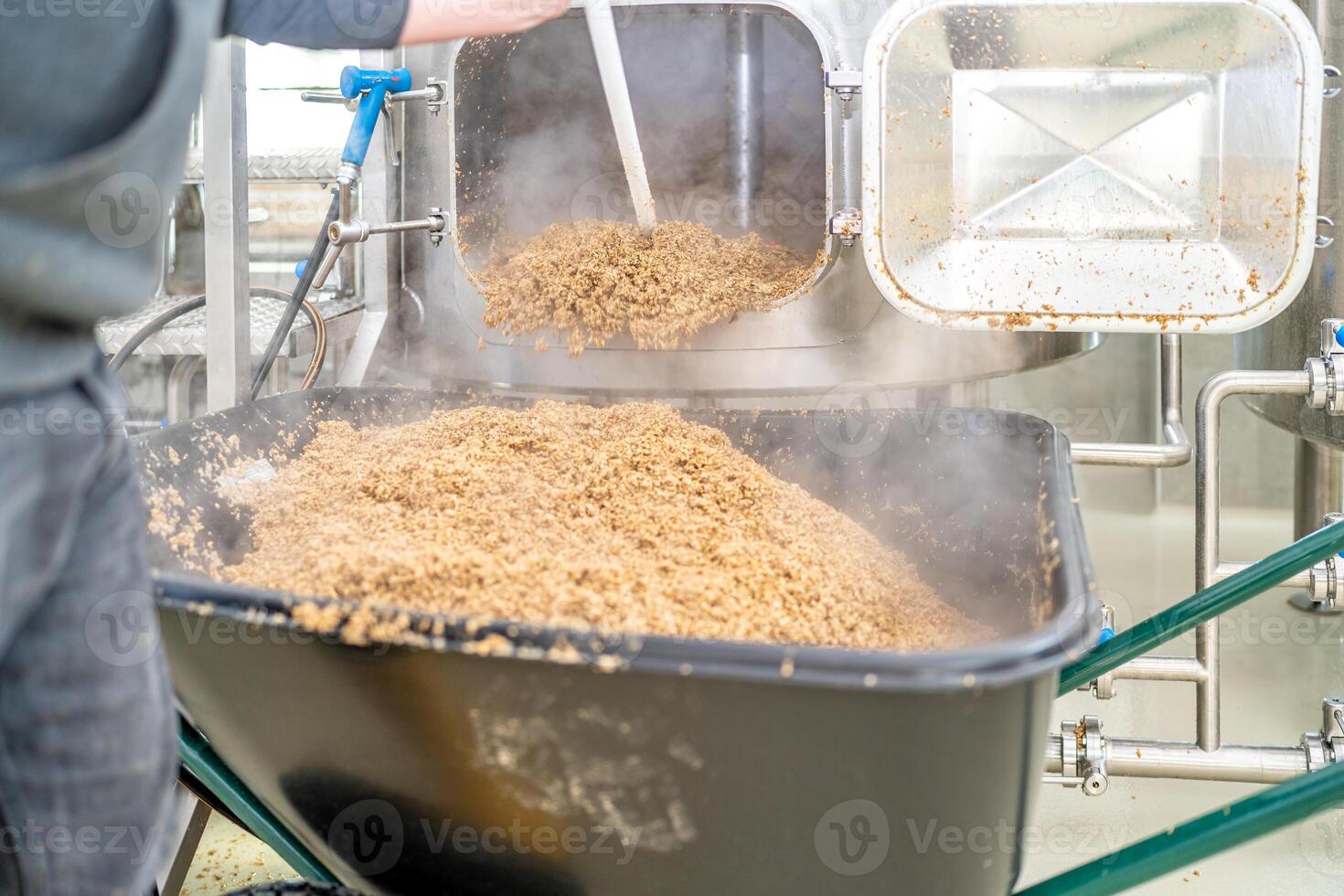 cleaning the boiler from residual malt after brewing beer in the brewery photo