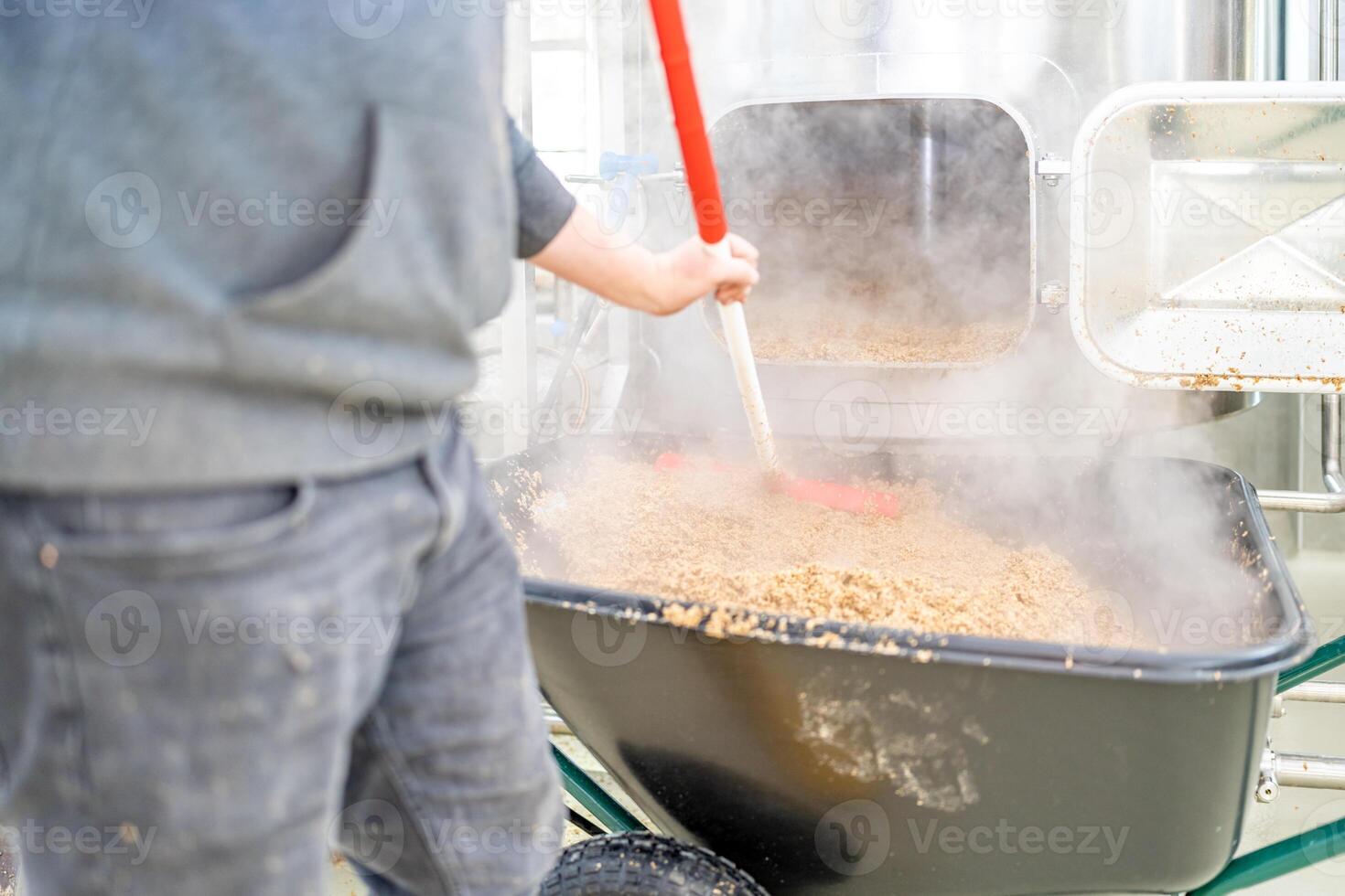cleaning the boiler from residual malt after brewing beer in the brewery photo