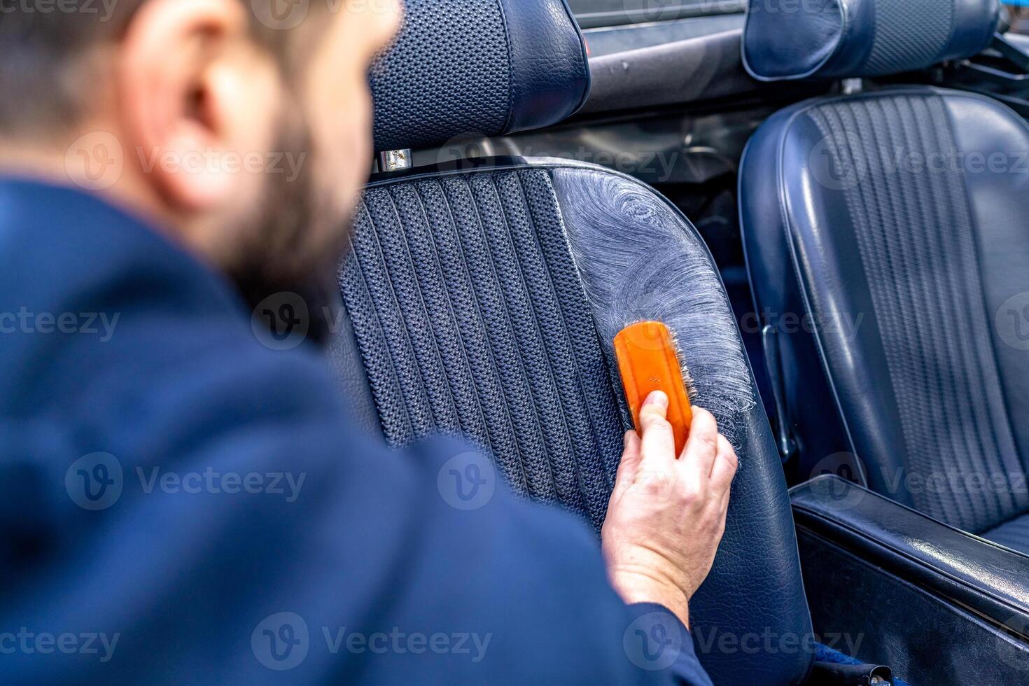 cleaning leather seats of luxury cars with the help of detergents and chemicals photo