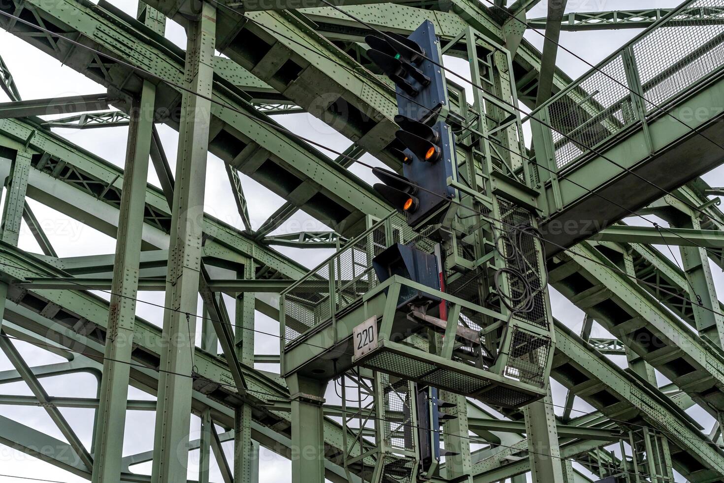 traffic lights for trains on the metal bridge of the railway line photo