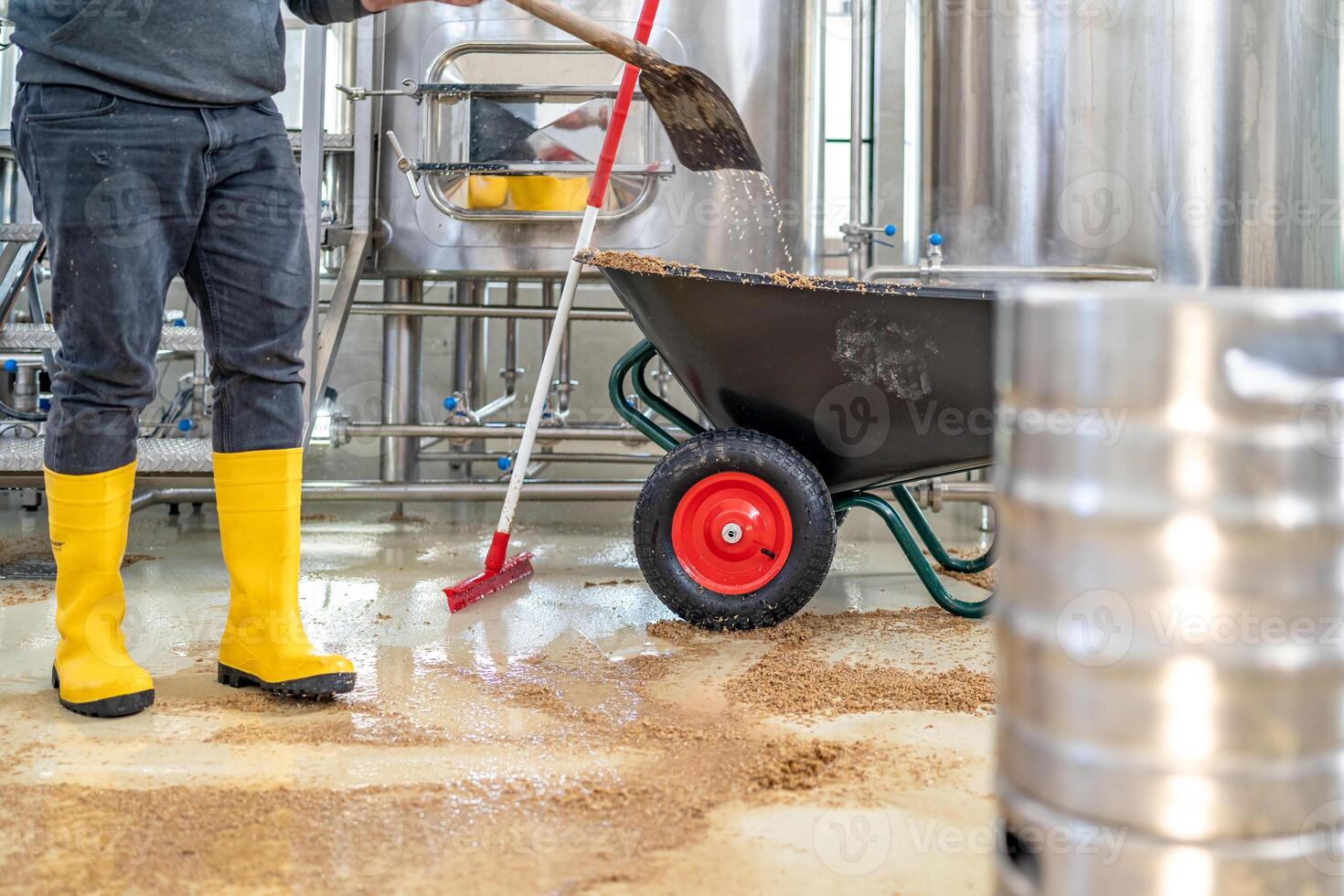 cleaning the boiler from residual malt after brewing beer in the brewery photo
