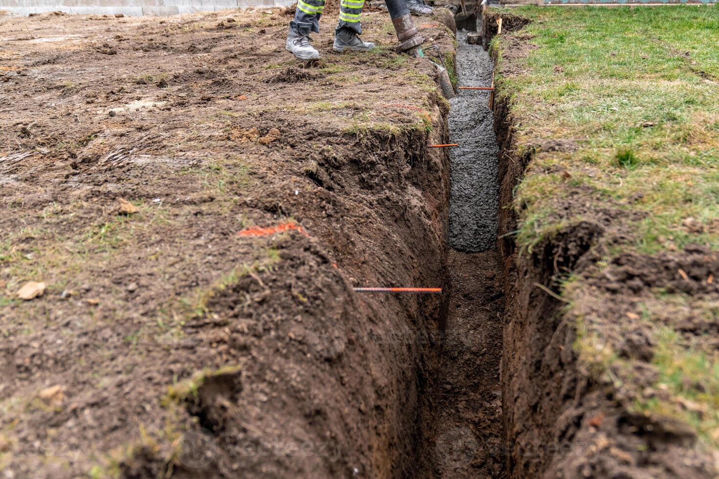 cementing the foundation in the ground when building a house photo