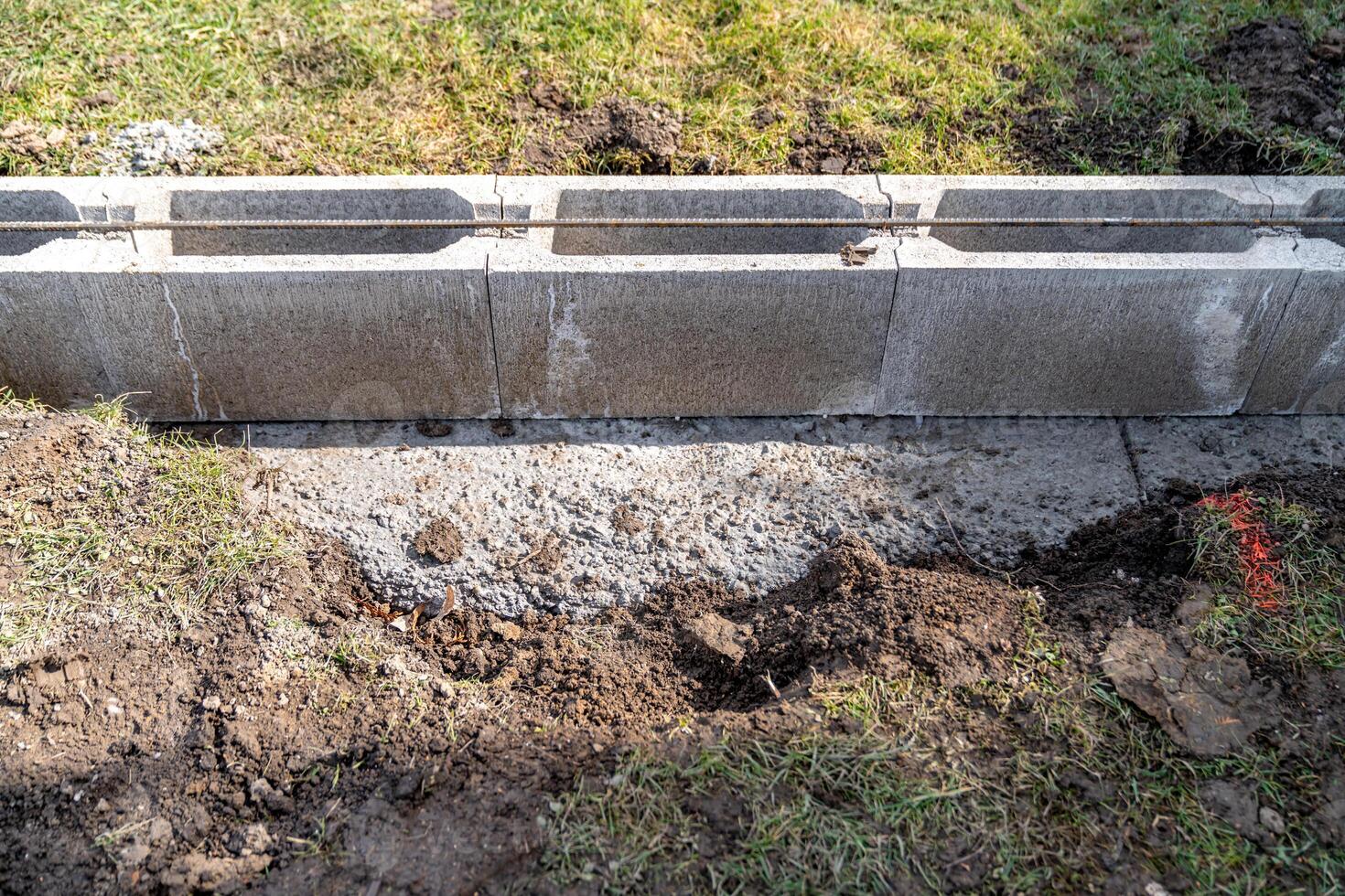 the foundation of the house is made of concrete blocks bound with metal armature photo