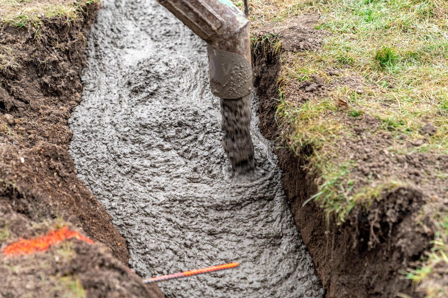 cementing the foundation in the ground when building a house photo