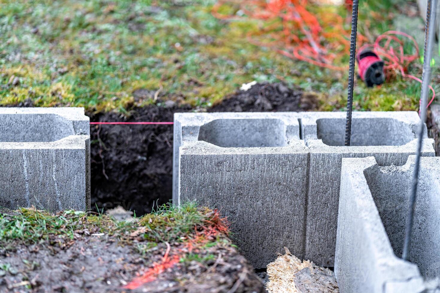 the foundation of the house is made of concrete blocks bound with metal armature photo