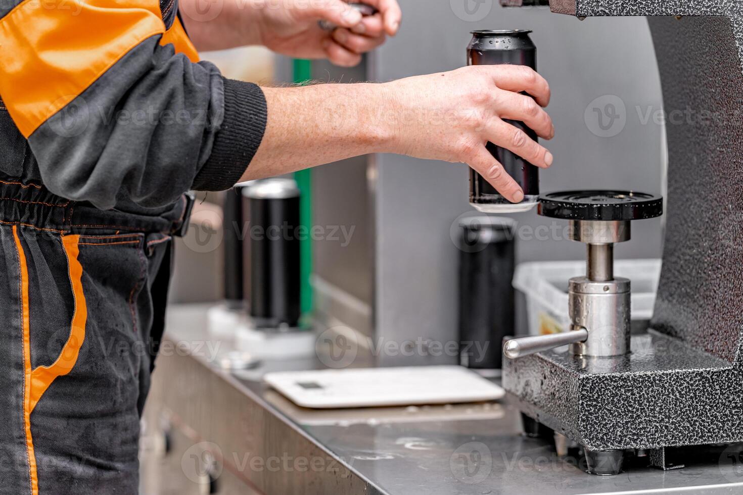 closed with the lid of beverage cans in an automatic capping machine in a brewery photo