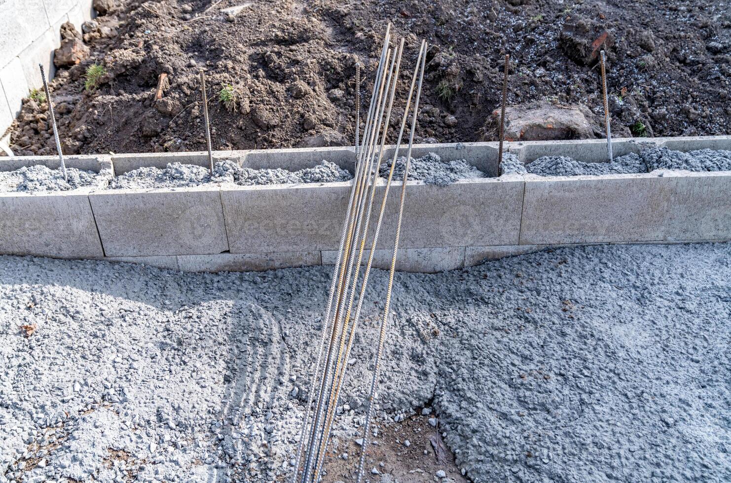 concrete foundation of the building with metal reinforcement photo
