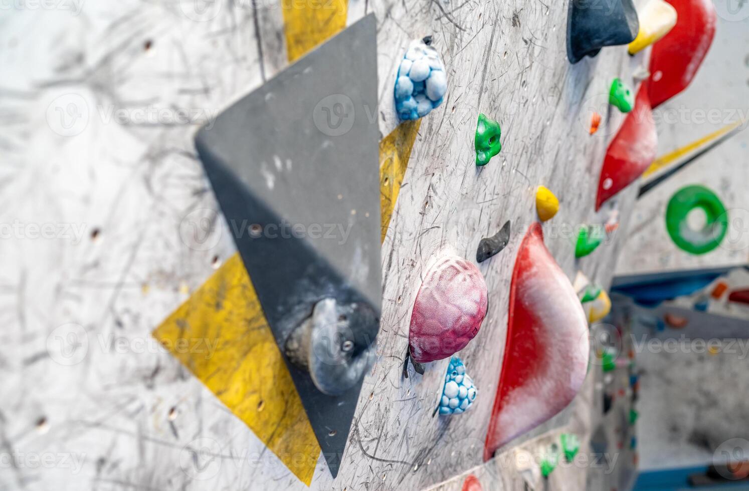 artificial climbing wall with colorful holds photo