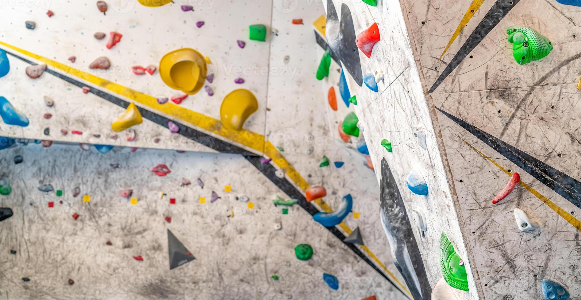 artificial climbing wall with colorful holds photo