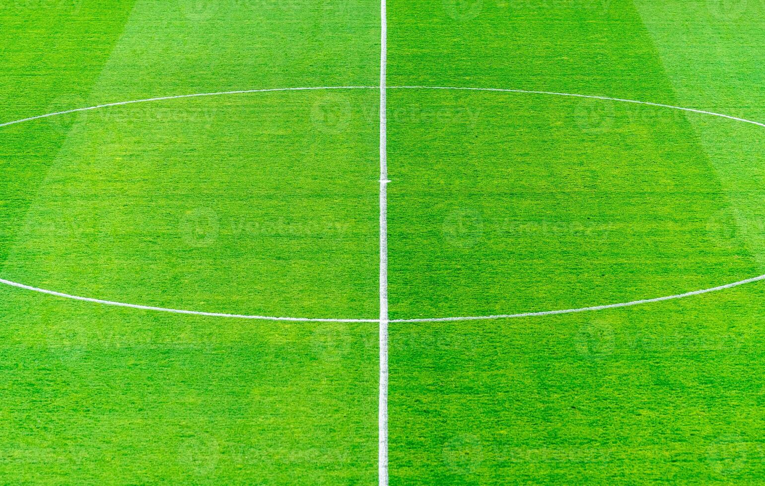 center of the football field, green lawn with white markings photo