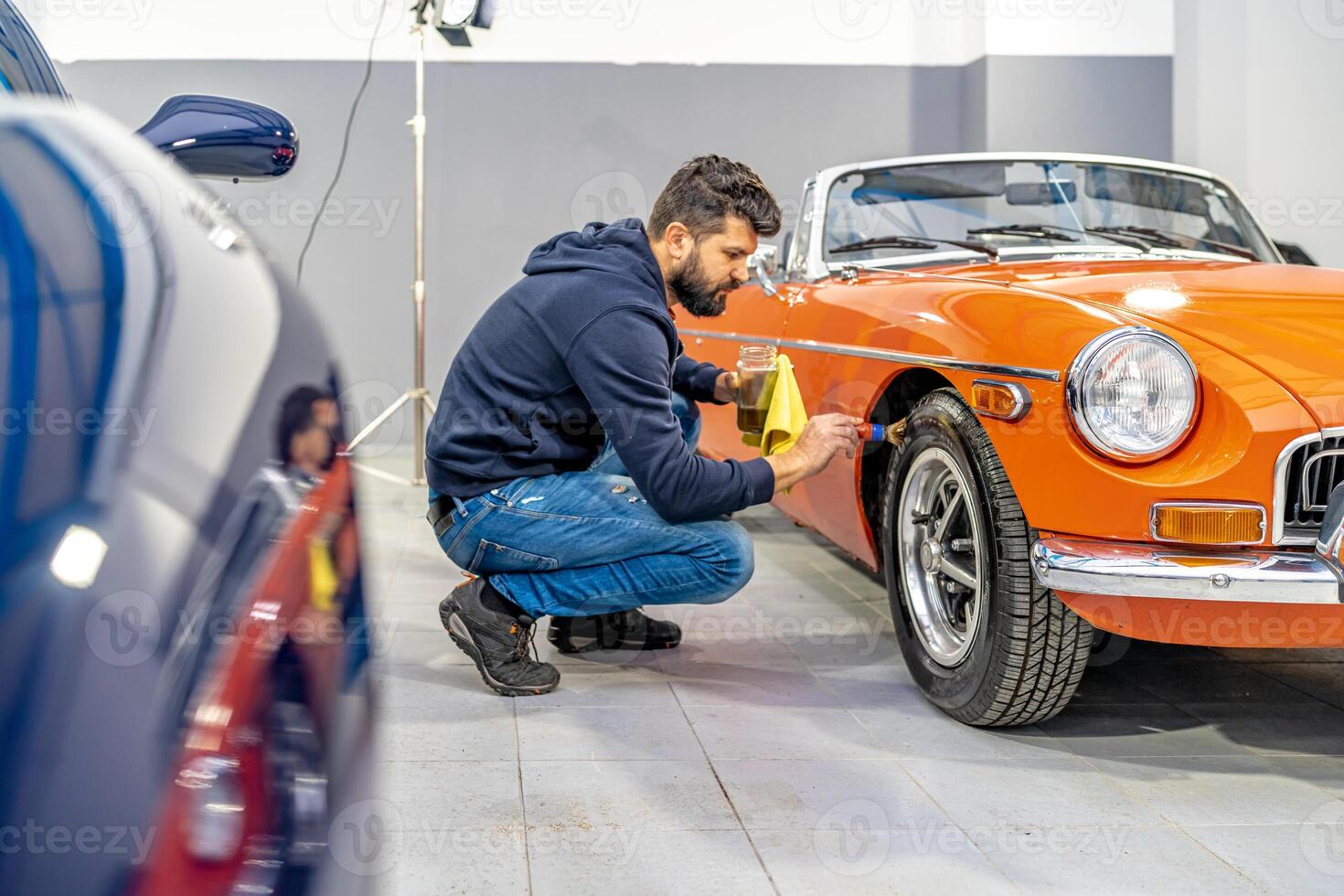 manual cleaning of car wheels and tires in the garage photo