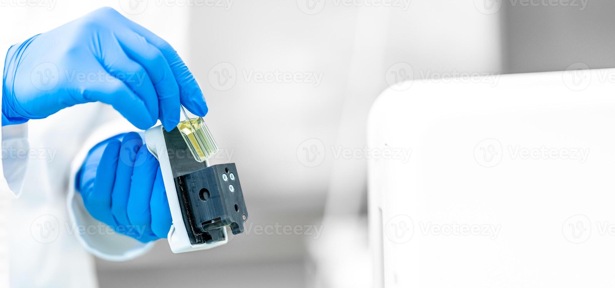 examination of a chemical sample using modern devices in the biochemical laboratory of the research institute photo