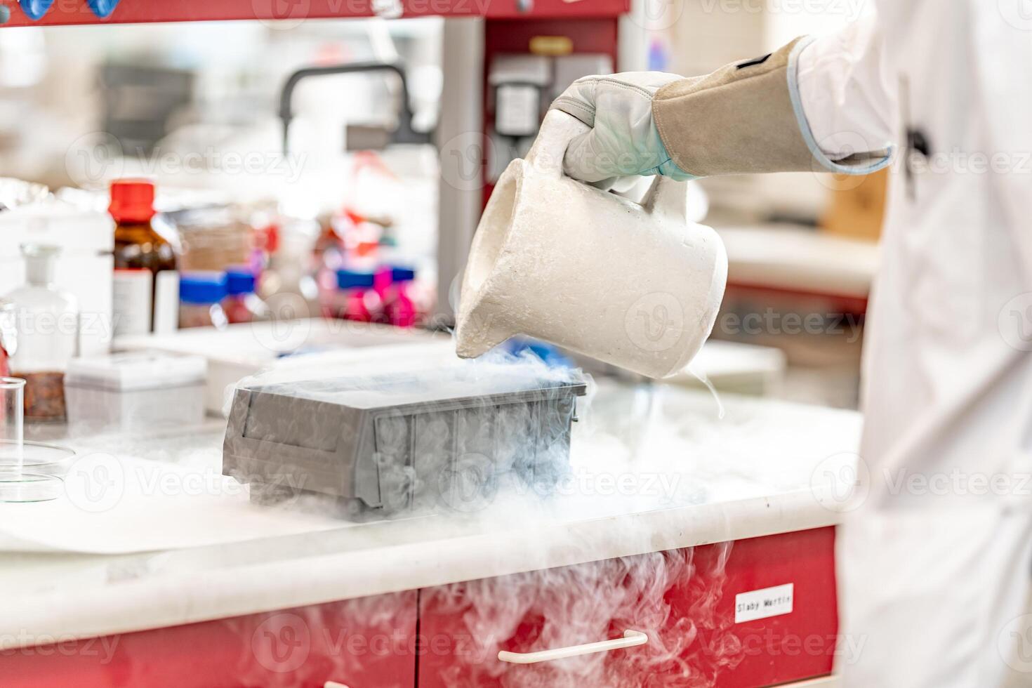 experiments with liquid nitrogen in the chemical laboratory. work and research with extreme temperatures photo