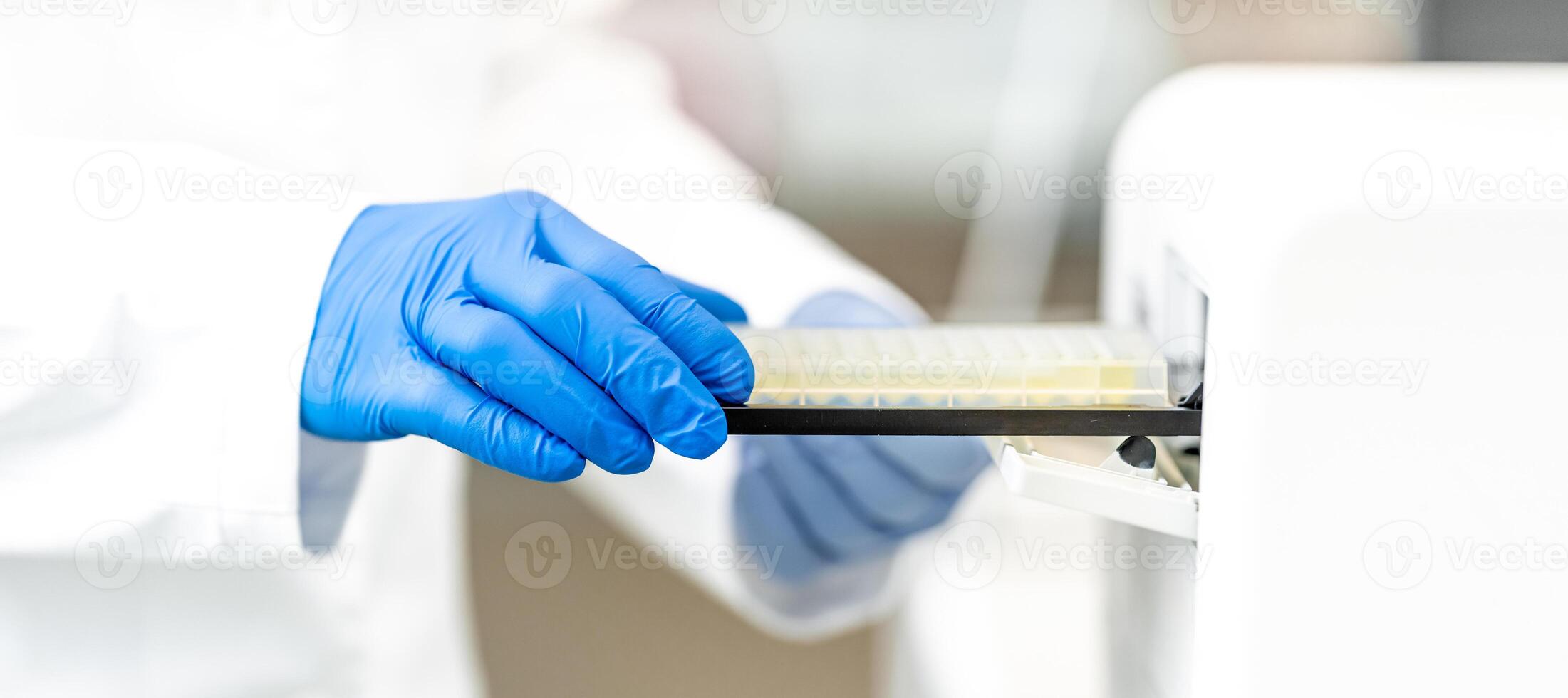 examination of a chemical sample using modern devices in the biochemical laboratory of the research institute photo