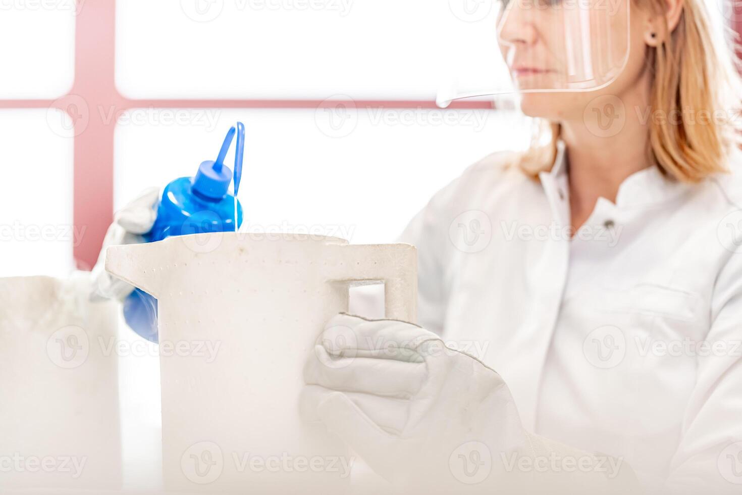 research of dangerous chemical substances in a biochemical laboratory. female scientist uses protective equipment photo