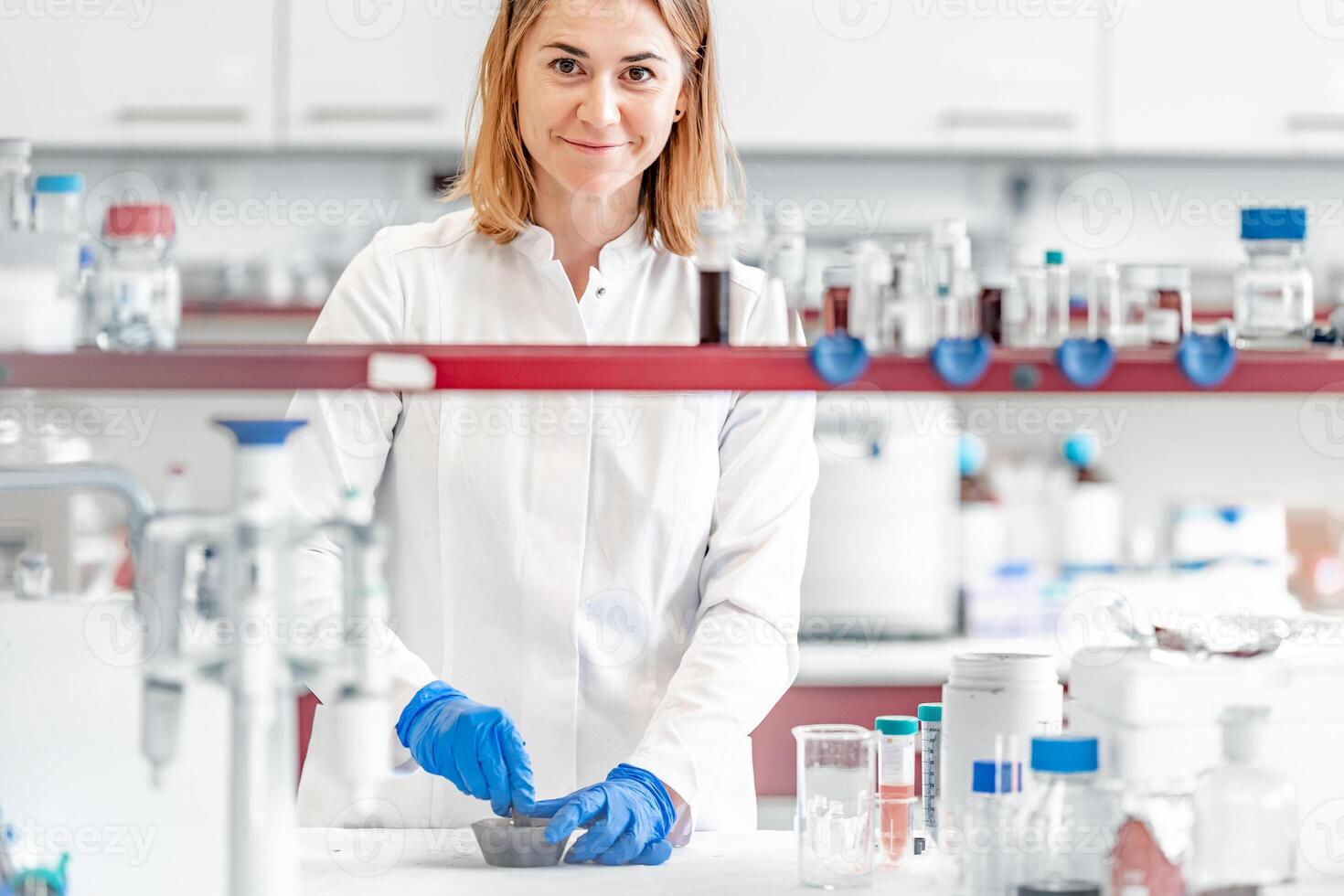 a female student at the science faculty of the university conducts biochemical research in the laboratory photo