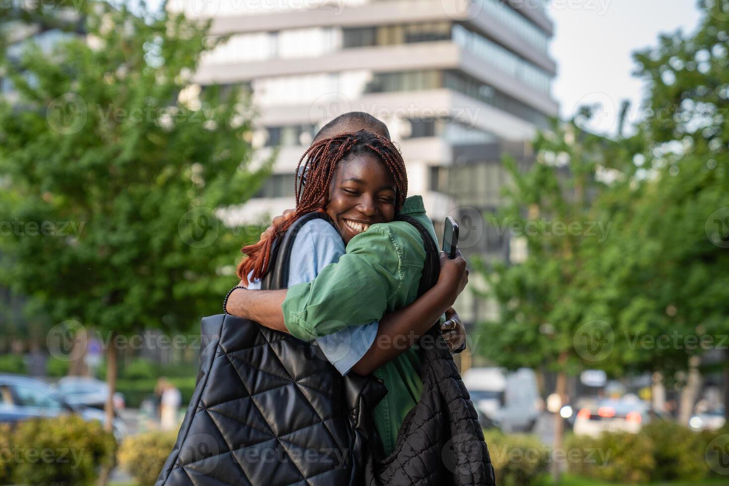 Long-awaited meeting of African American couple girl and guys with smiles, hugs for walking together photo