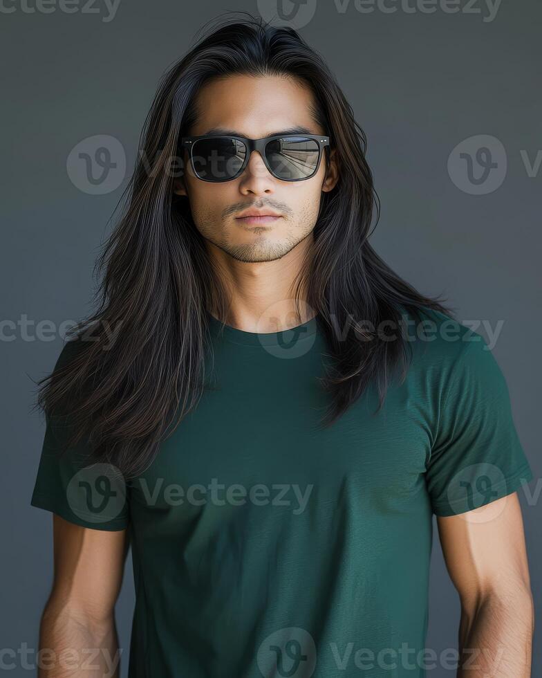 Handsome model poses confidently wearing a blank green t-shirt and sunglasses photo