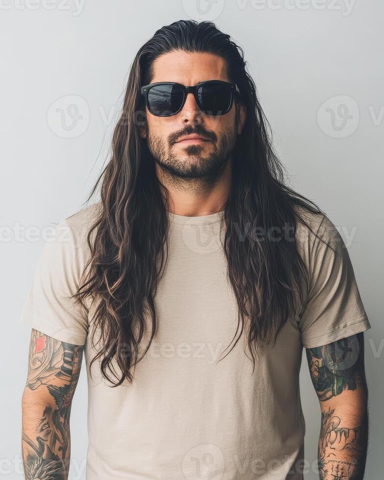 Stylish model wearing a blank t-shirt poses confidently in soft natural light photo