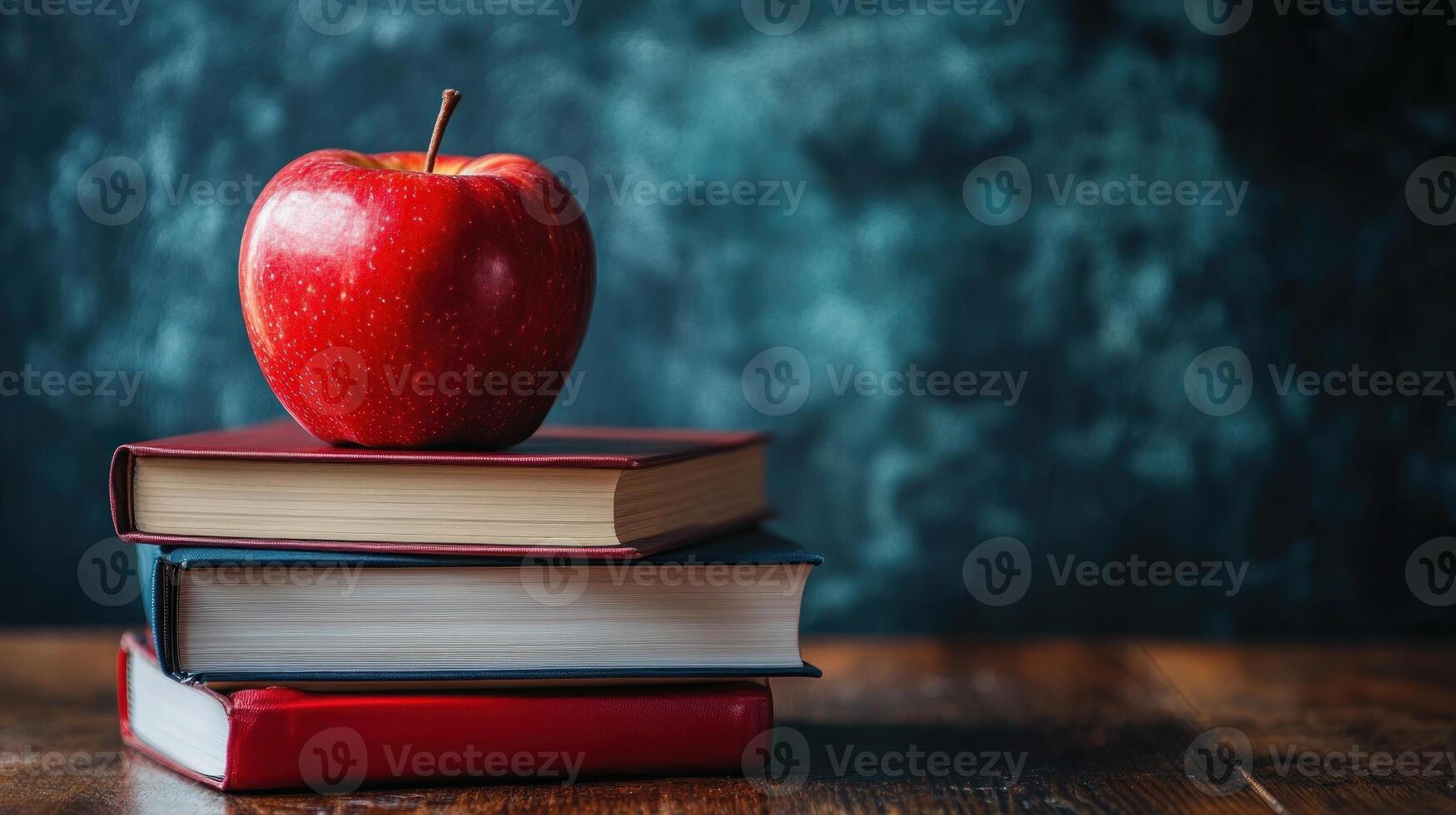 A book with an apple on top of it photo