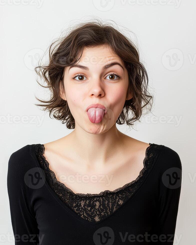 A woman expresses her playful side by sticking out her tongue photo