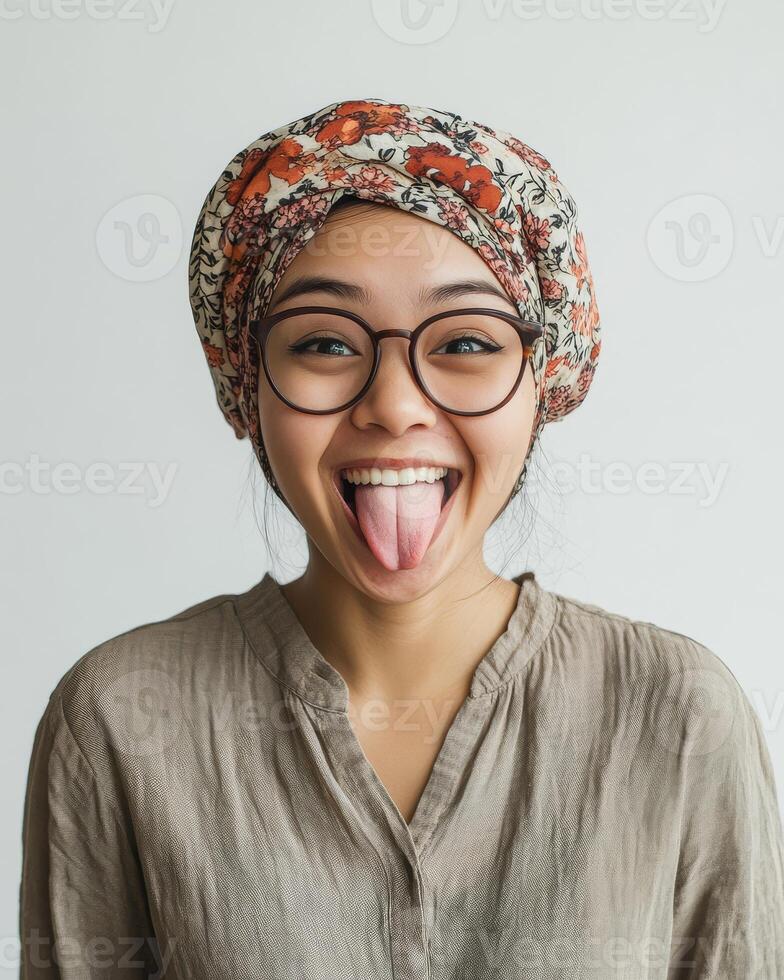A cheerful young woman shows her playful side with a bright expression photo