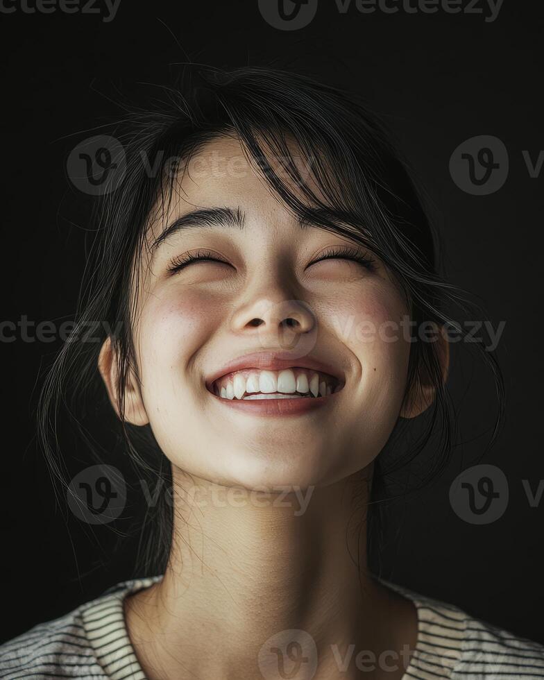 A young woman grins with genuine happiness, reflecting pure joy photo