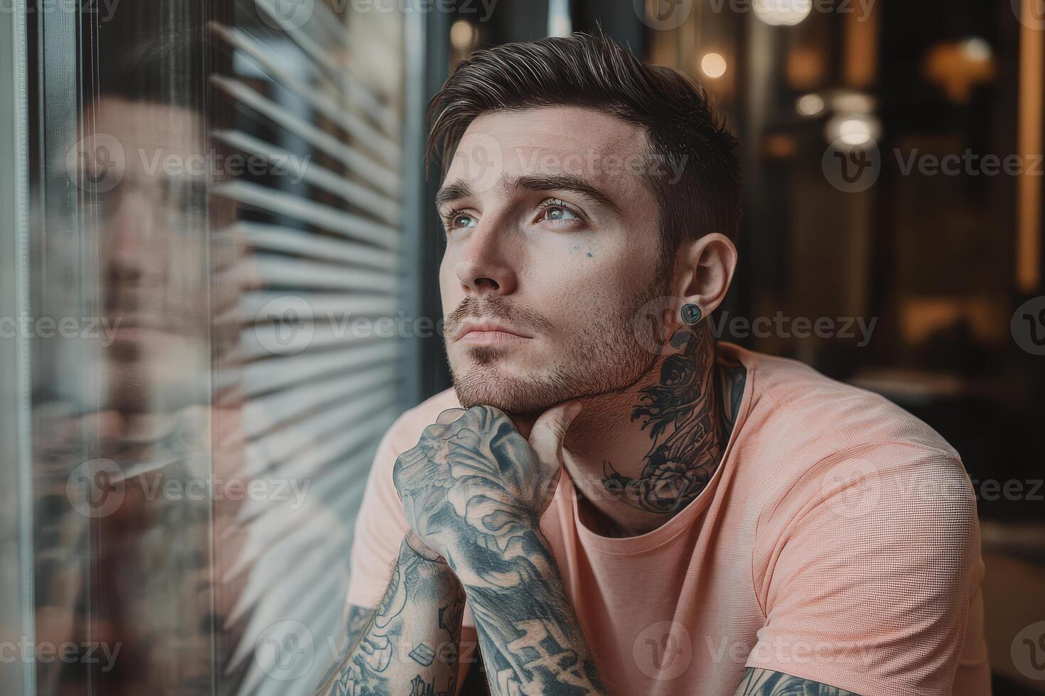 A man lost in reflection while enjoying a quiet moment indoors photo