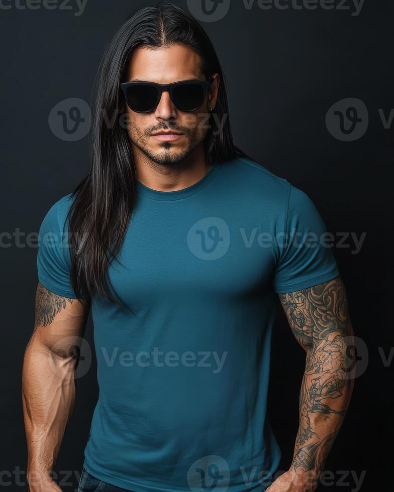 A model poses confidently in a blank t-shirt against a dark backdrop photo