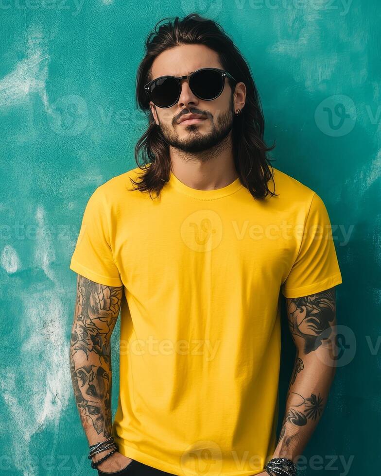 A stylish model poses confidently in a yellow t-shirt and sunglasses photo