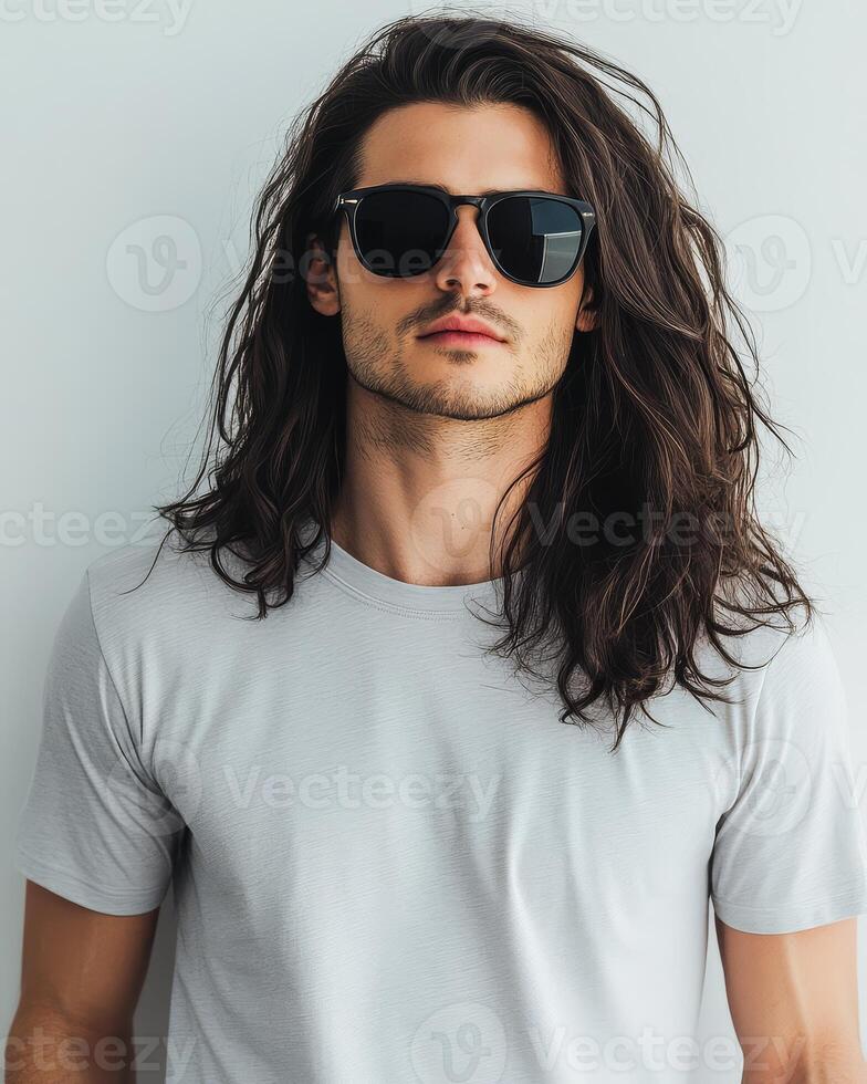 A stylish young man poses confidently in a blank t-shirt and sunglasses photo