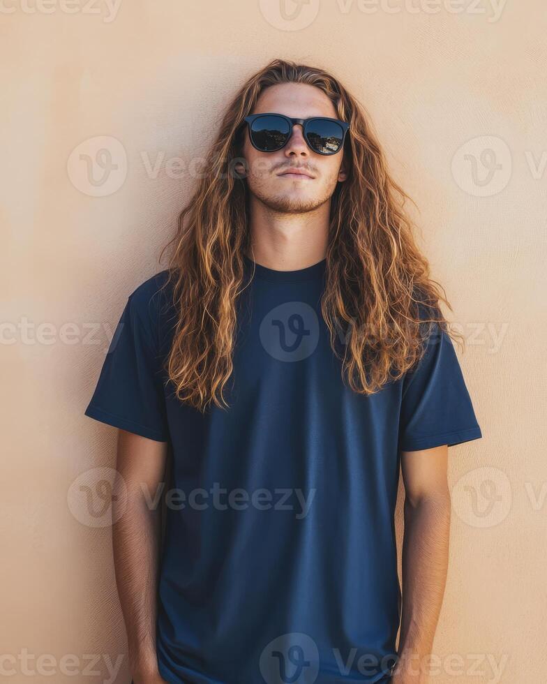 Man with long hair poses confidently in a blank t-shirt and sunglasses photo