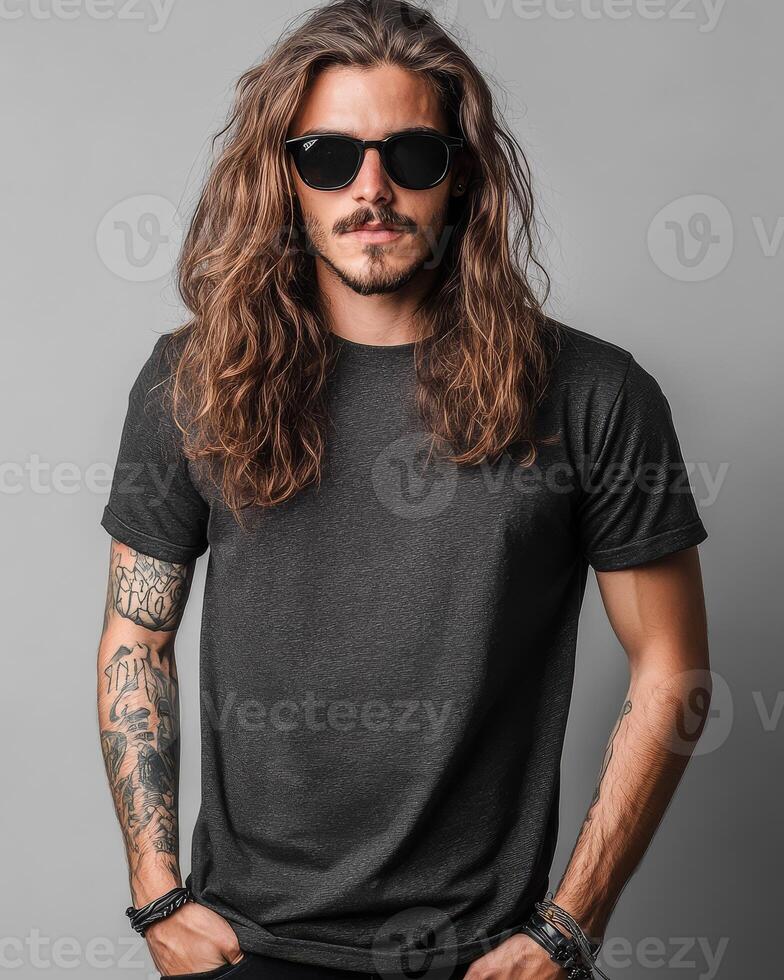 Handsome model in a blank t-shirt poses confidently with long hair photo