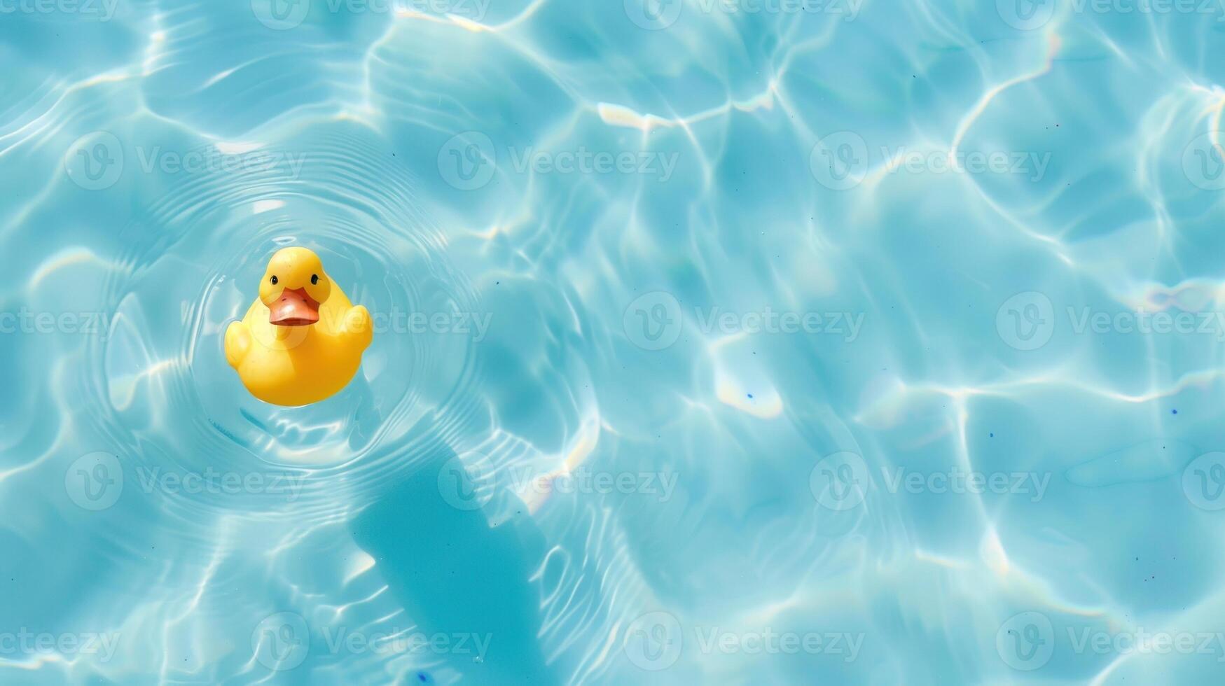 A yellow rubber duck is floating in a pool of water photo