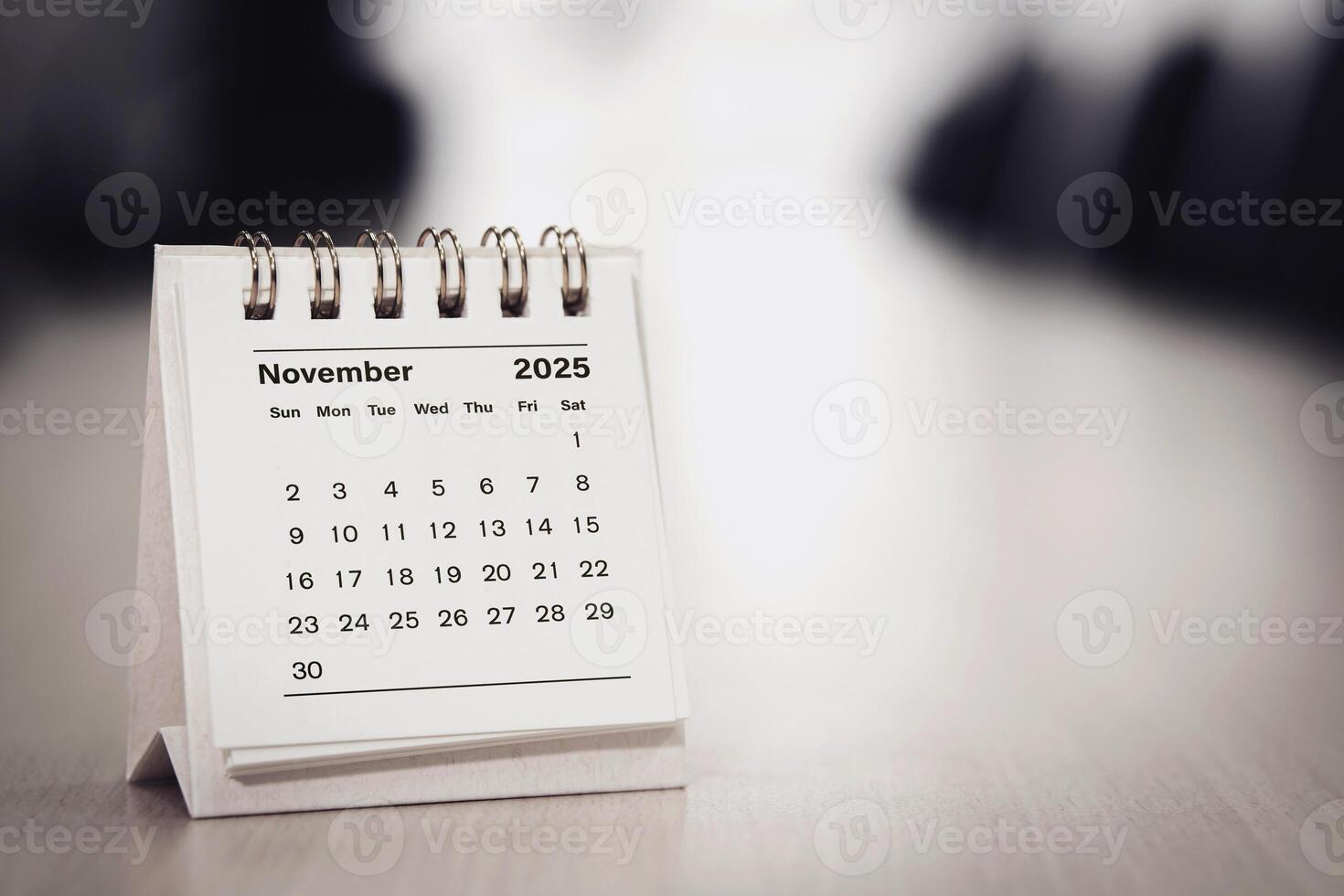 Calendar page November of the year 2025 white color in meeting room in office. with copy space and business design. concept of planning and setting new strategic goals. photo
