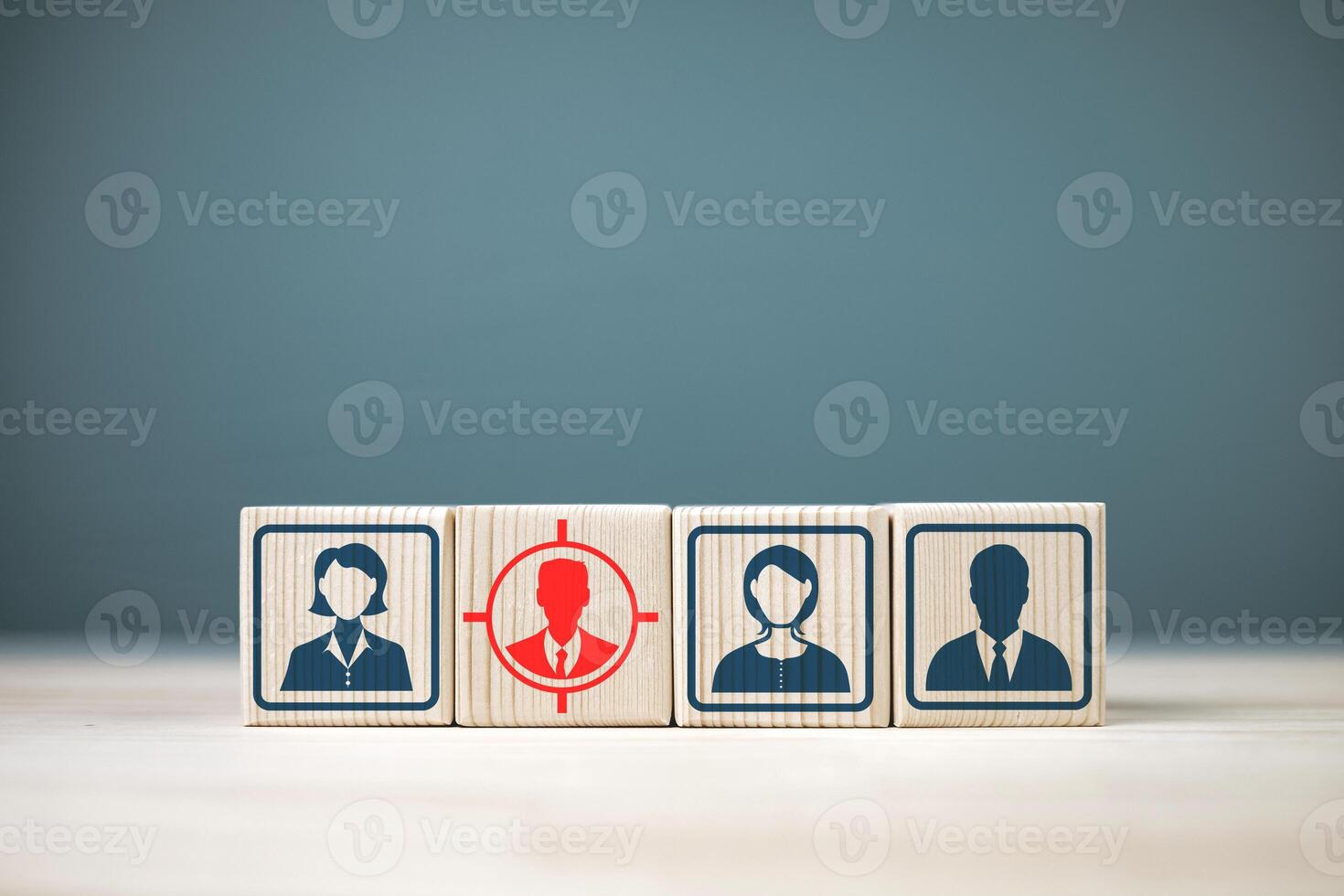 Marketing and planning for selecting target customers, strategies for increasing sales to customers, and human resource management. Human icon on wooden cube focusing on red target human photo