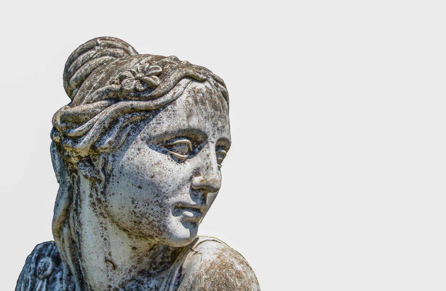 Sand stone beautiful lady face sculpture isolated on white background. photo