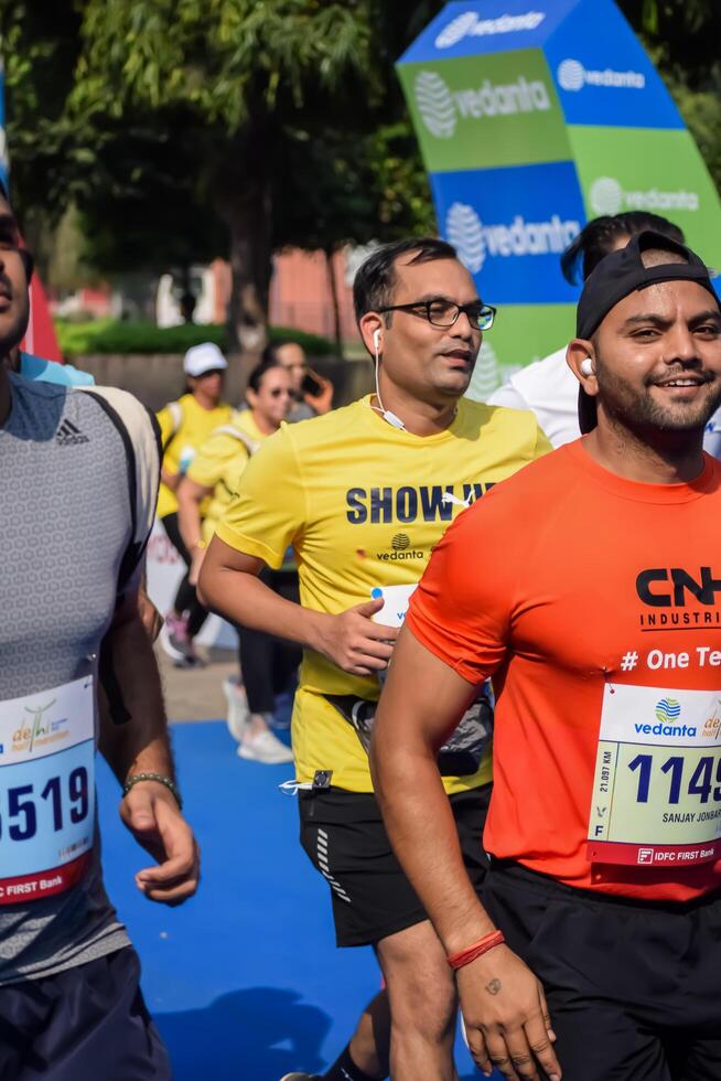 New Delhi, India - July 15 2024 - Vedanta Delhi Half Marathon race after covid in which marathon participants about to cross the finish line, Delhi Half Marathon 2023 photo