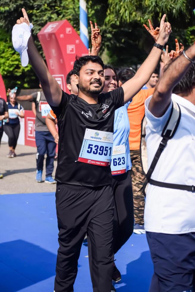 New Delhi, India - July 15 2024 - Vedanta Delhi Half Marathon race after covid in which marathon participants about to cross the finish line, Delhi Half Marathon 2023 photo